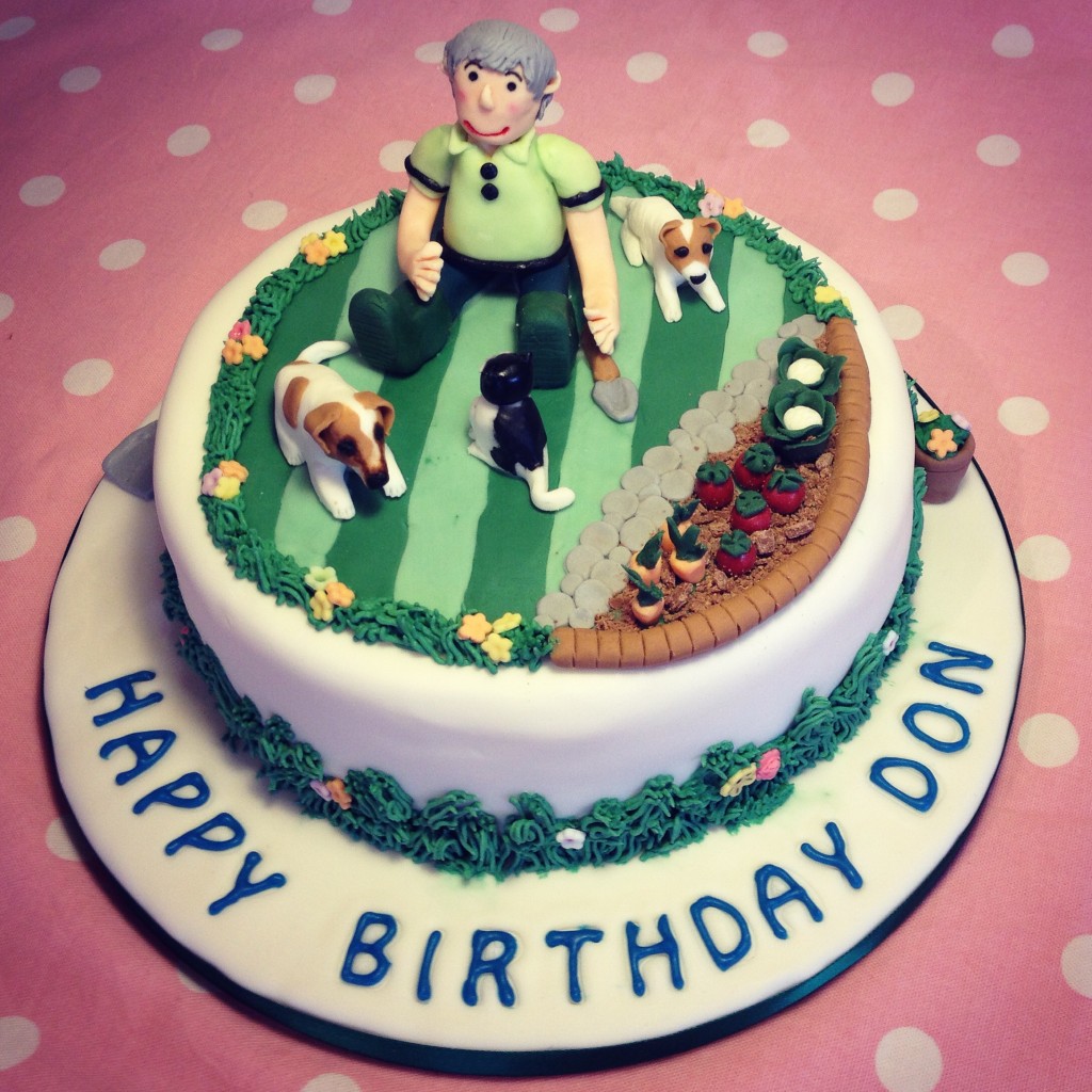 Birthday cake with a garden theme, handmade dogs and a cat made from the owners pictures.